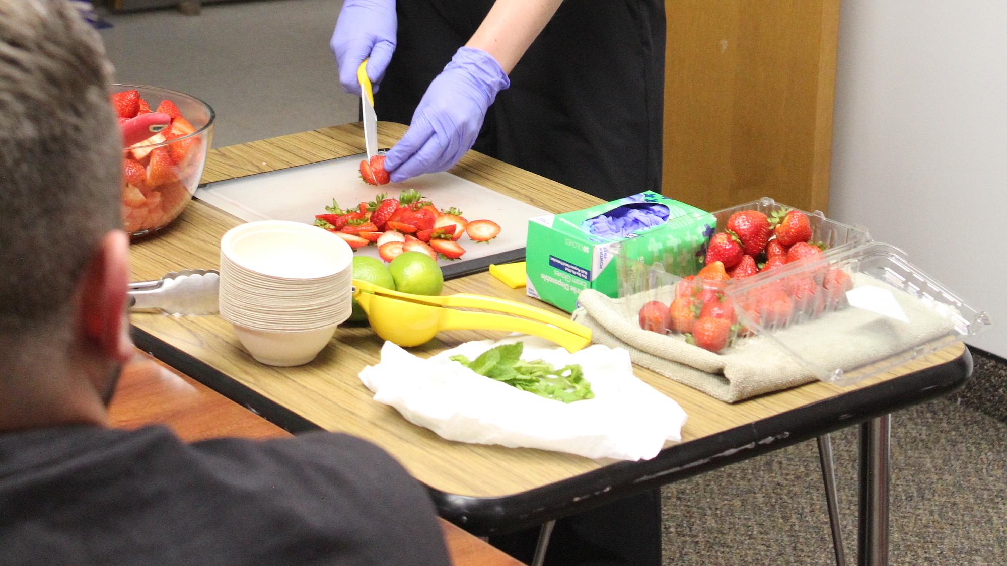 Madeleine French prepares a strawberry-citrus salad during a Journey to Health cooking demonstration.