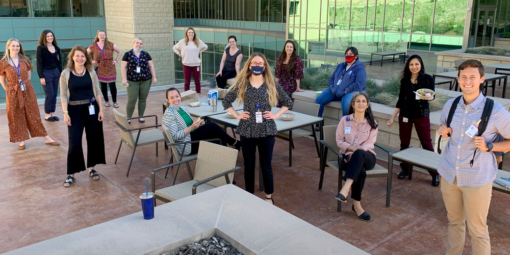 Ulrich Group standing around lunch tables on the Research South Patio of Huntsman Cancer Institute