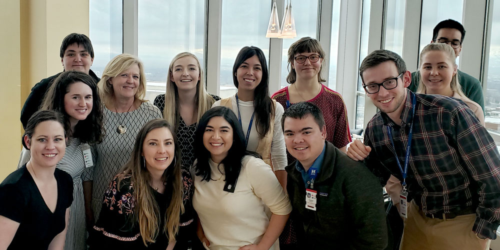 Ulrich Group leaning in for photo at the Point Restaurant in Huntsman Cancer Institute