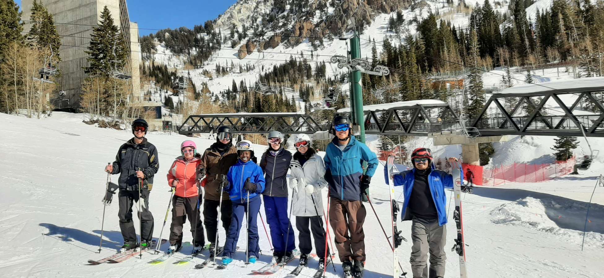 Group photo of Snyder Lab members wearing ski gear and standing in snow