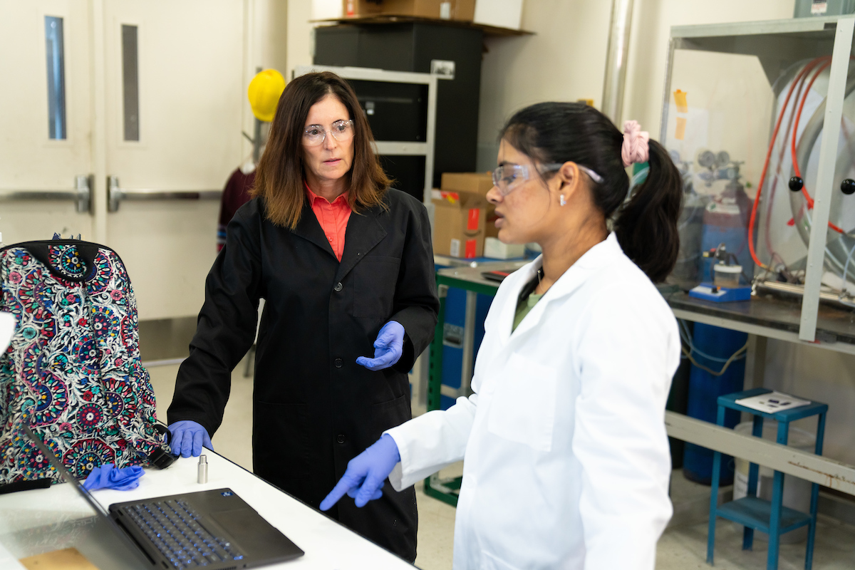 Chemical engineering professor Kerry Kelly, left, consults with postdoctoral researcher Kamaljeet Kaur in the lab.