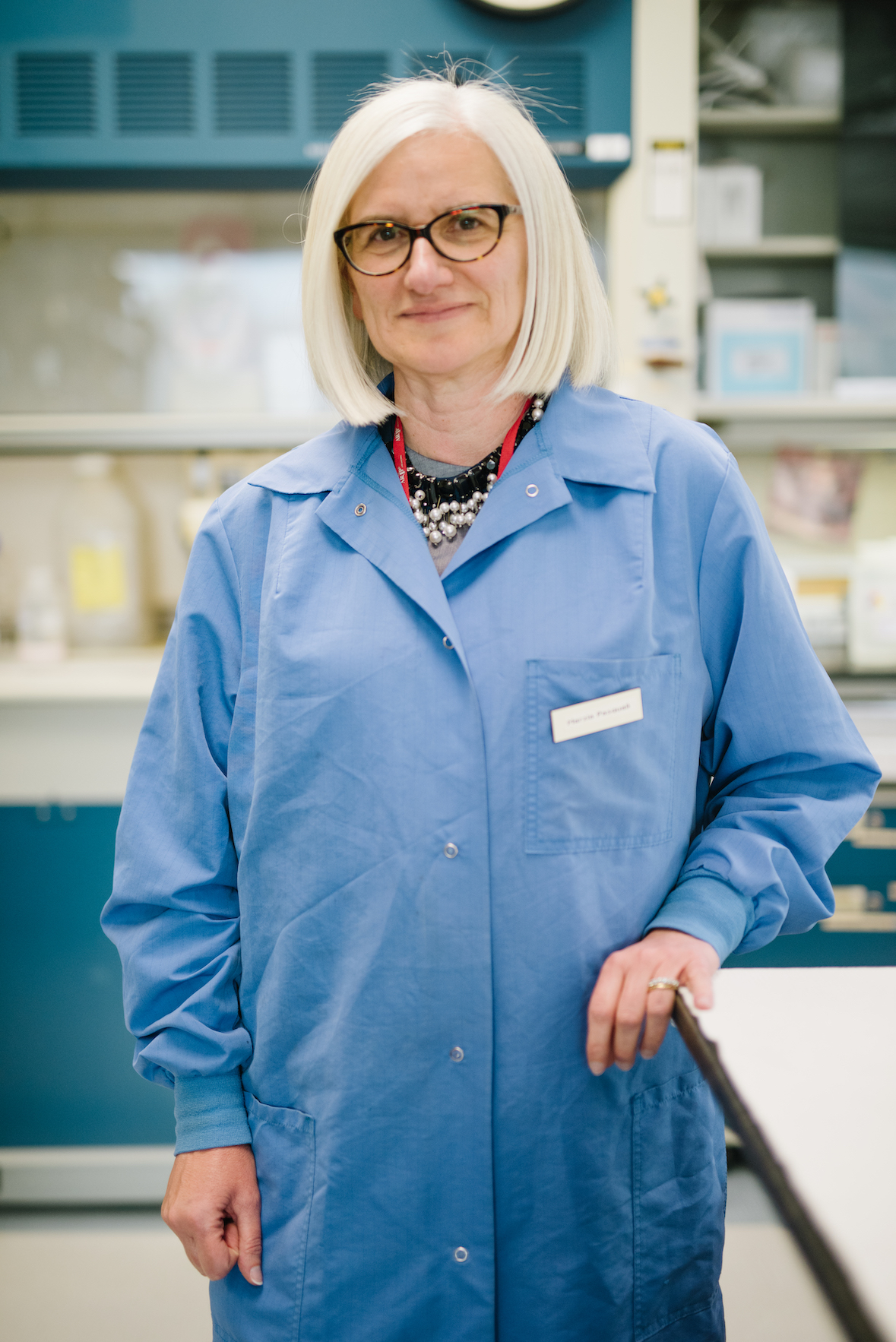 Marzia Pasquali, PhD, standing in the laboratory.