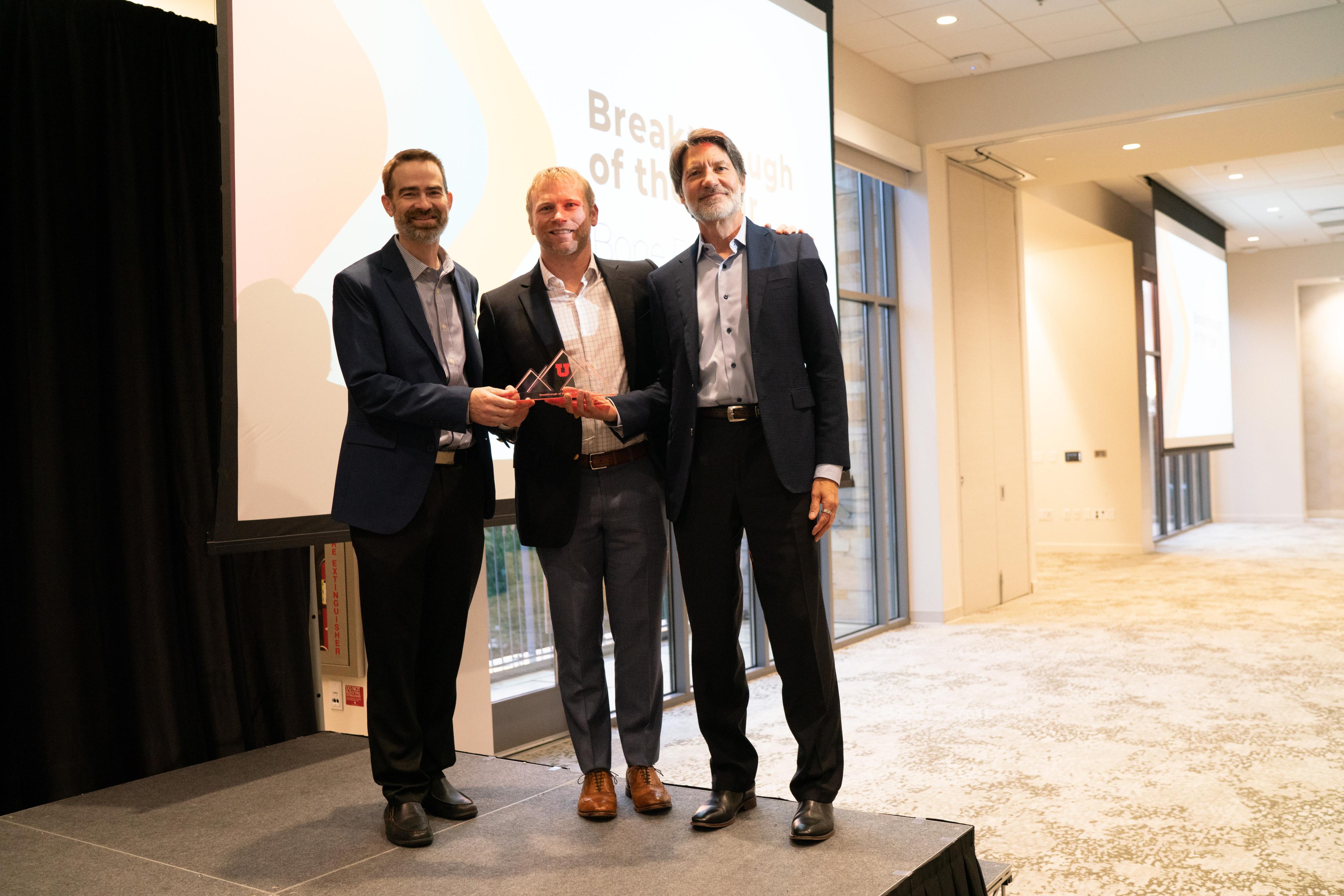 Wade Fallin, Colin Gregersen and Justin Haller, MD, at the Orthopaedic Innovation Center receiving the University of Utah Breakthrough of the Year award.
