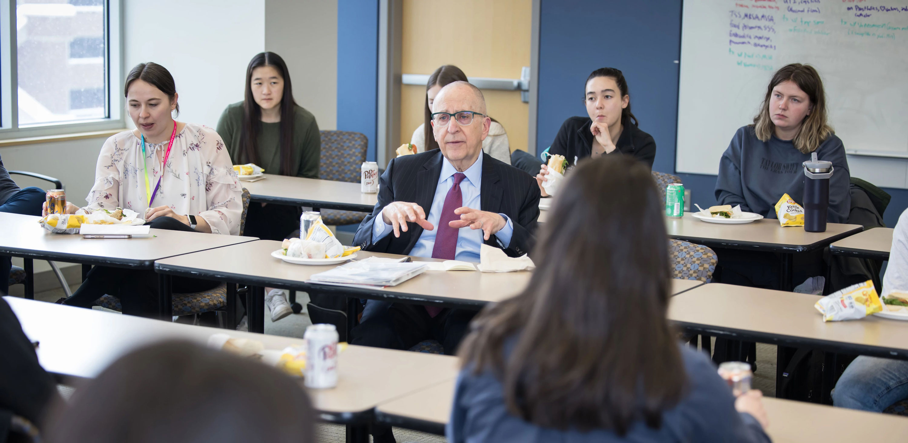 David Skorton talking with students at Spencer Fox Eccles School of Medicine