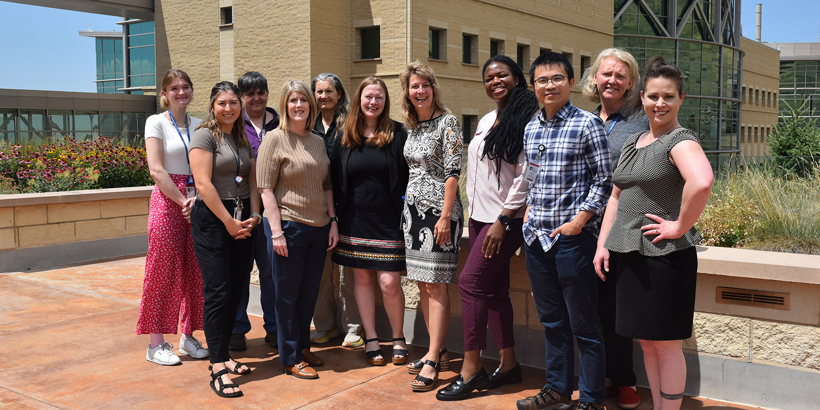 Ulrich Group members smiling at camera in a line on the staff patio