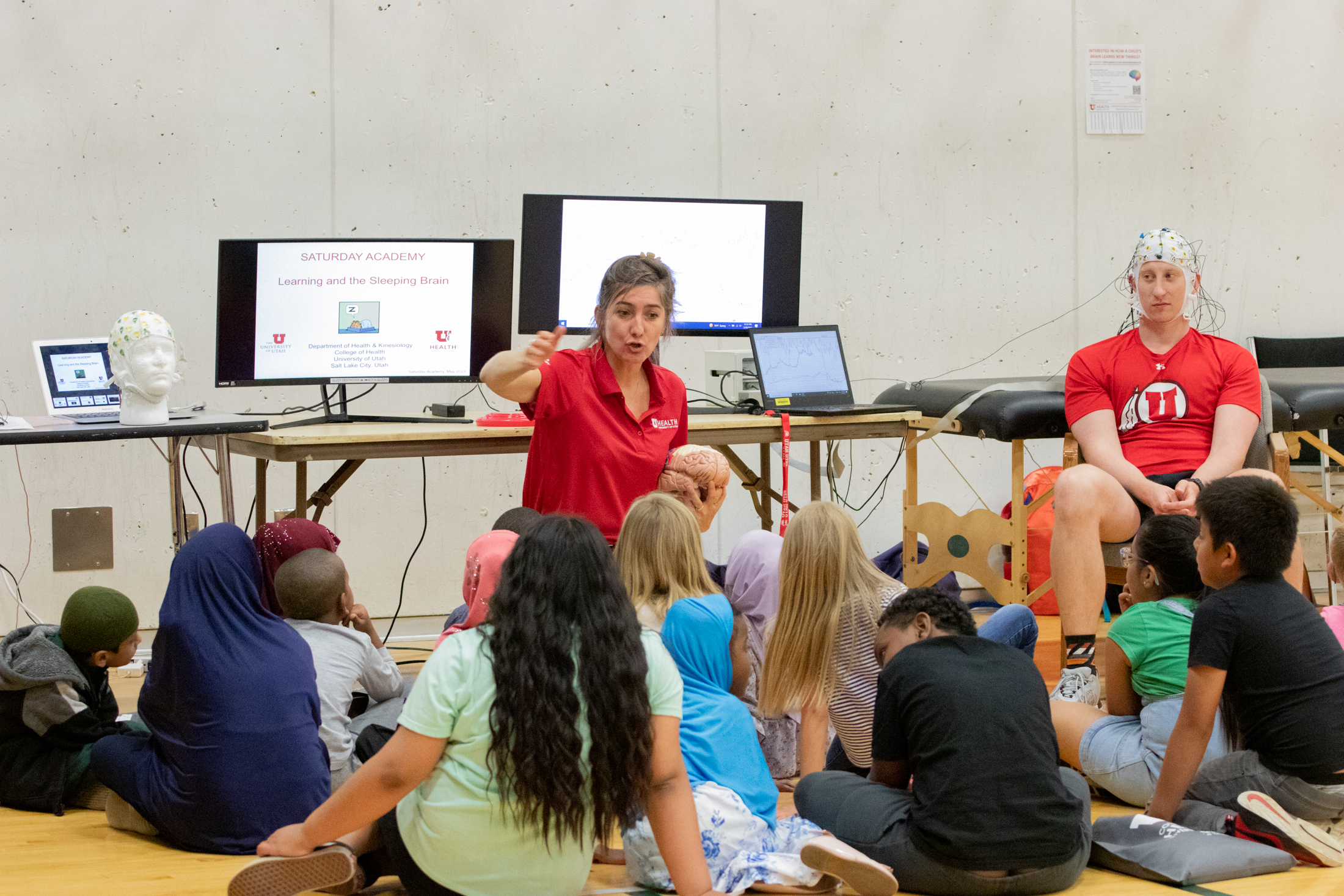 Two adults present health care professions to K-12 students