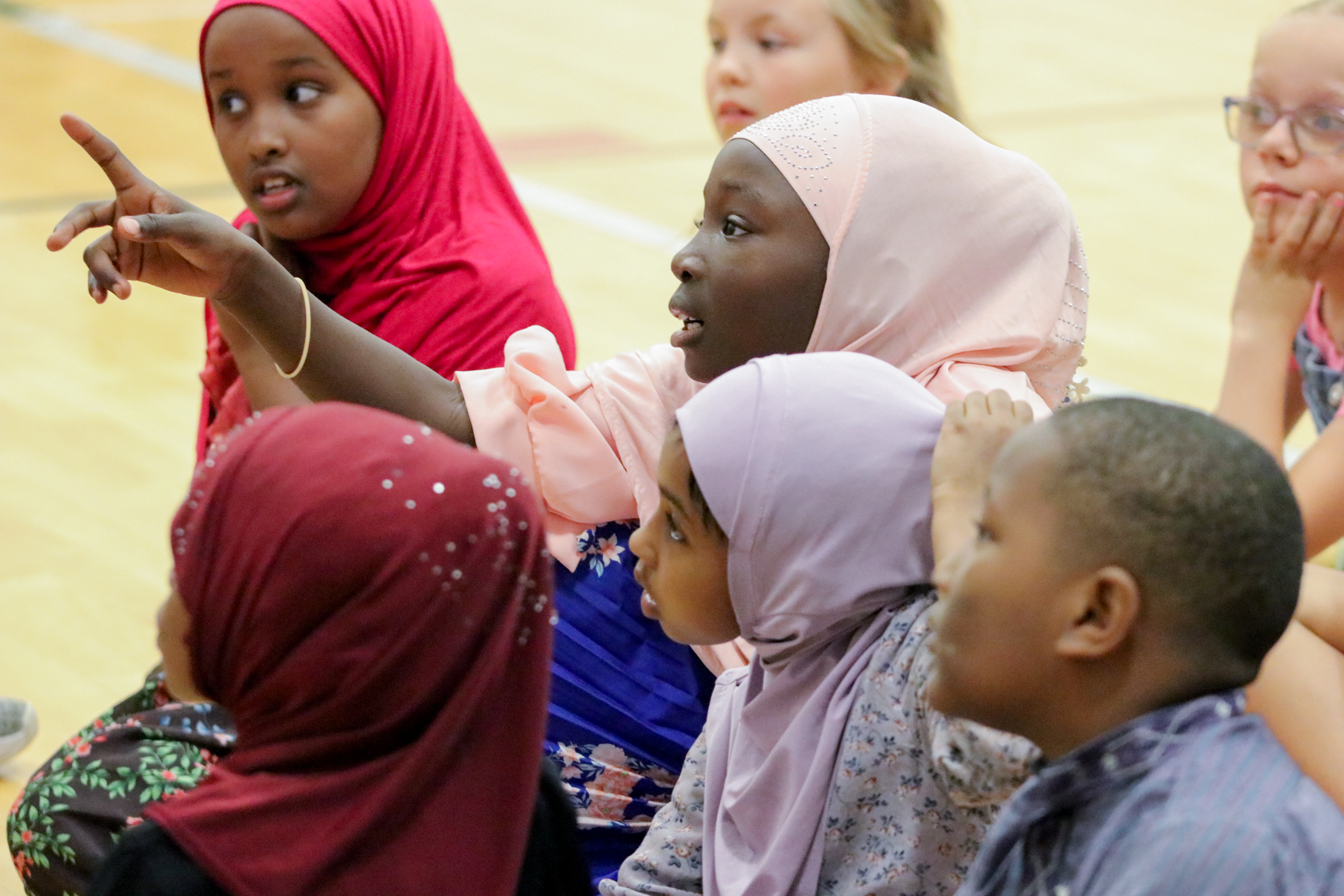 K-12 students listening to presenters
