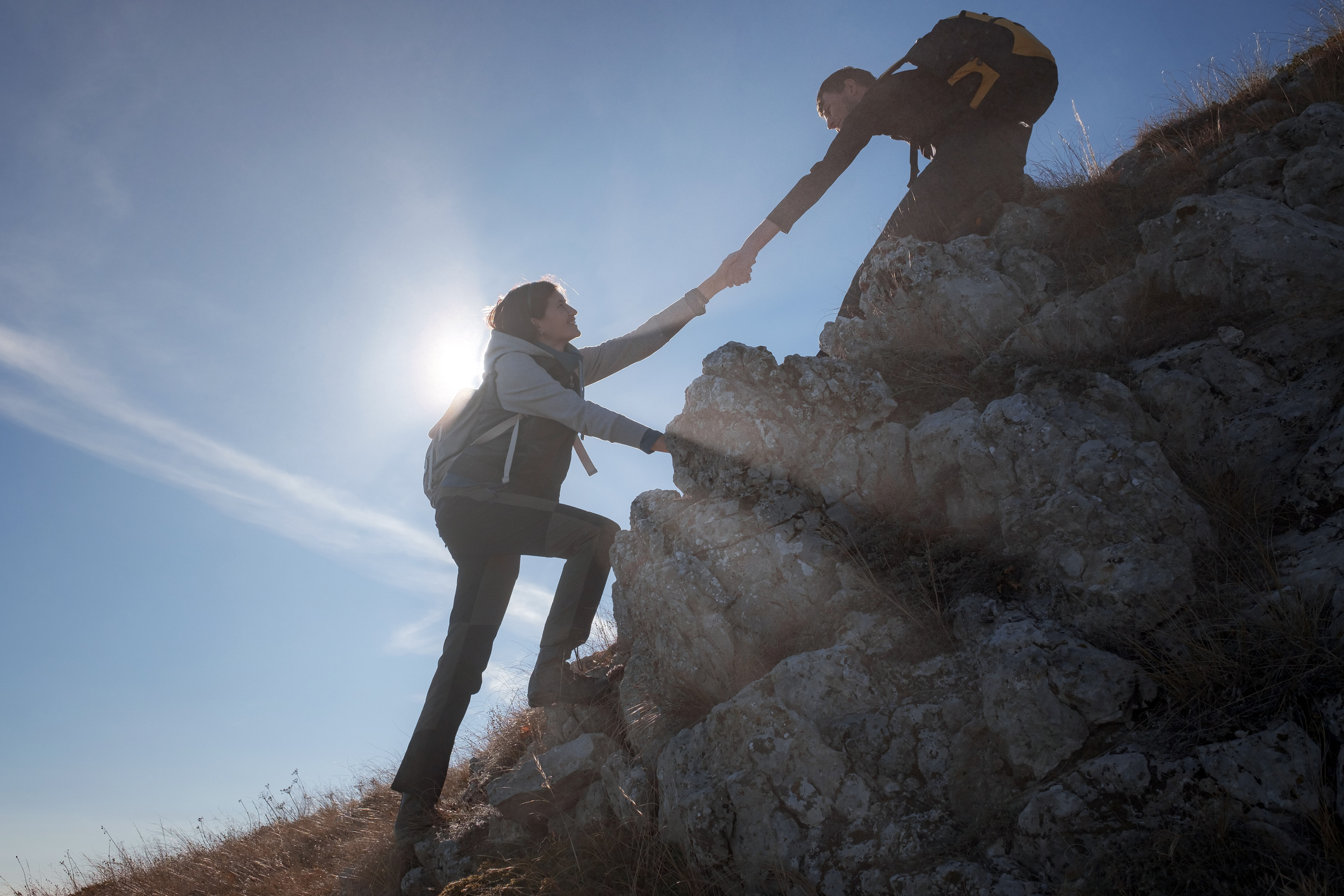 Two people climbing mountains