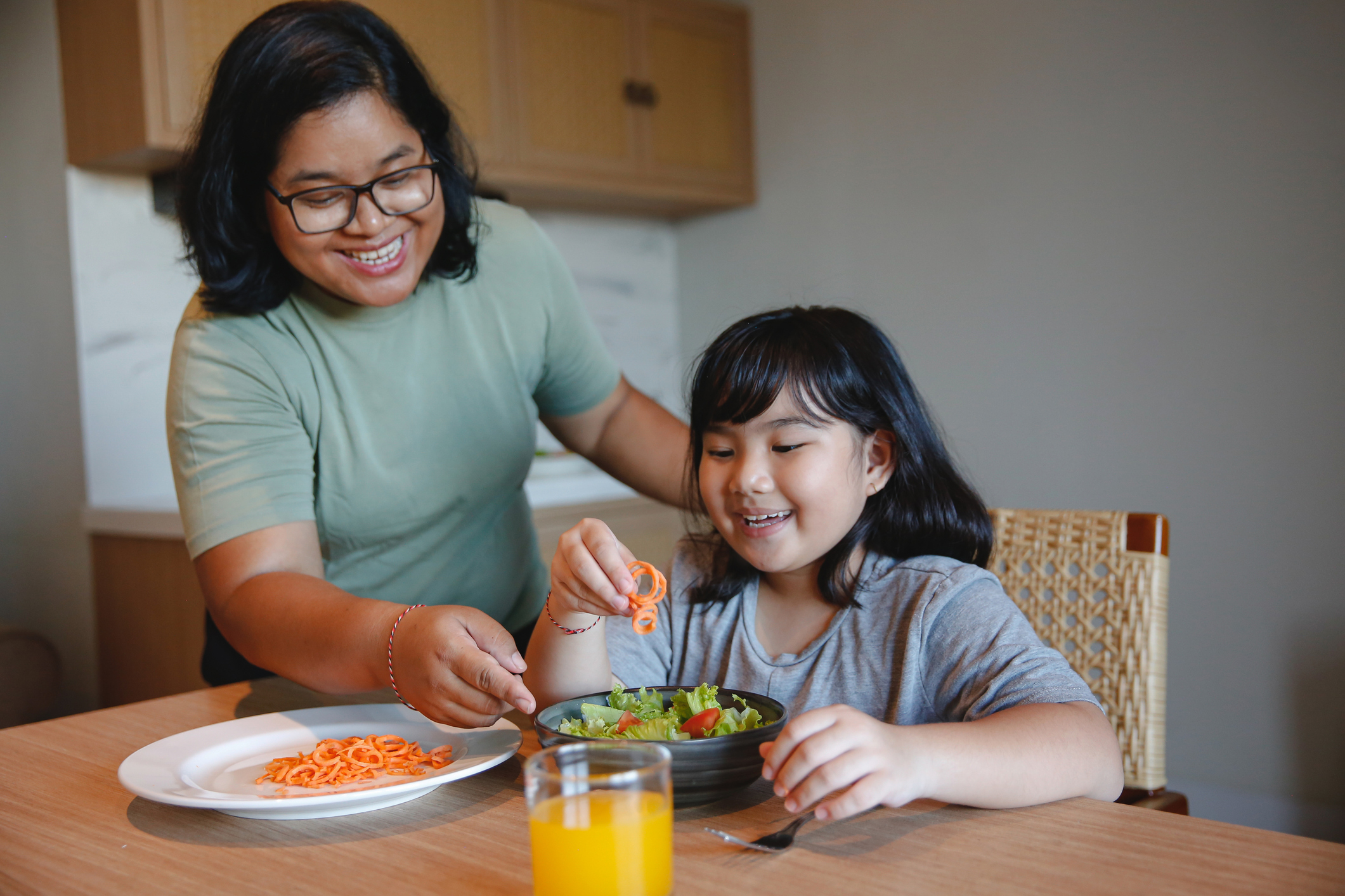 Adult serving child health food.