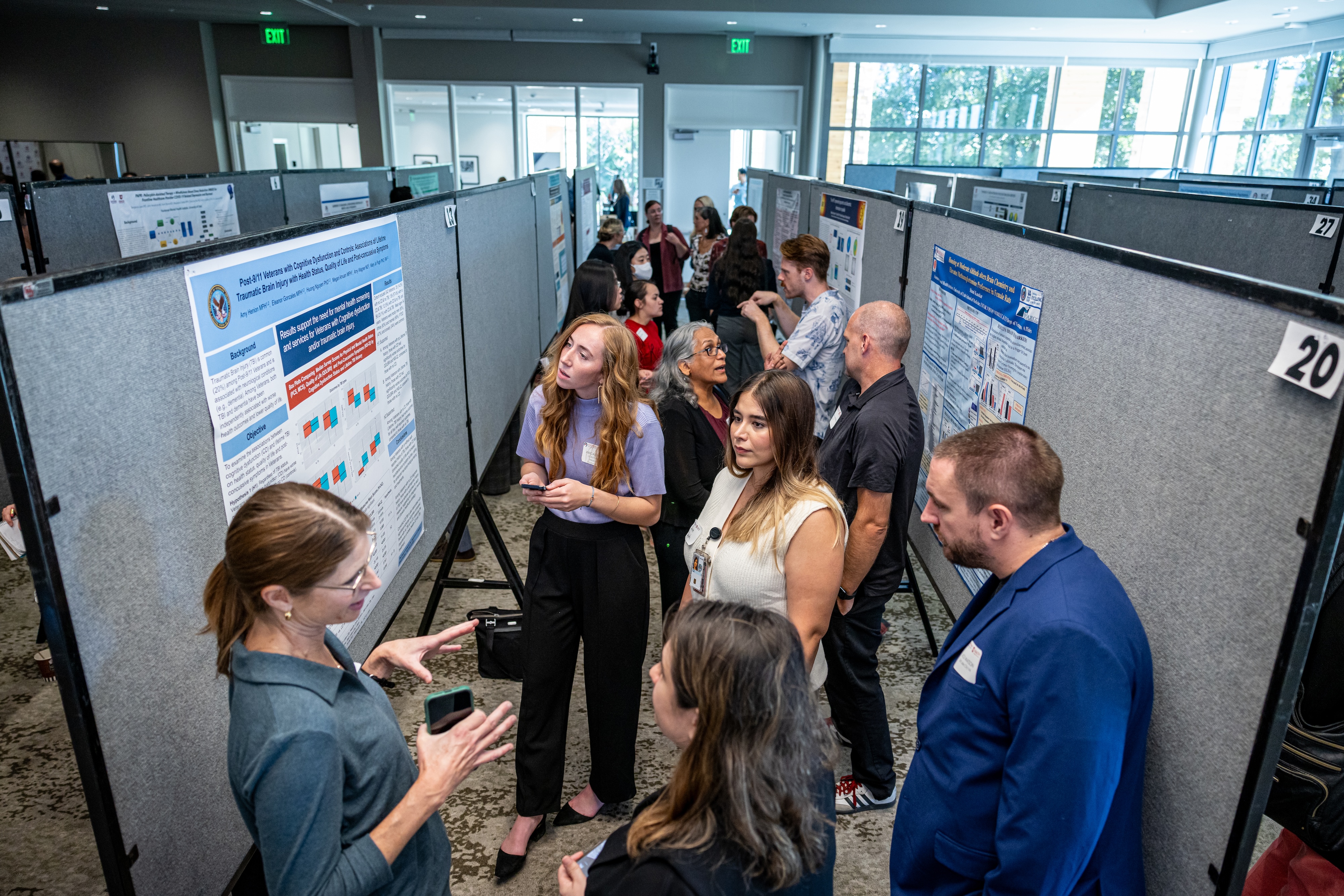 Elevated view of a packed poster hall full of researchers.