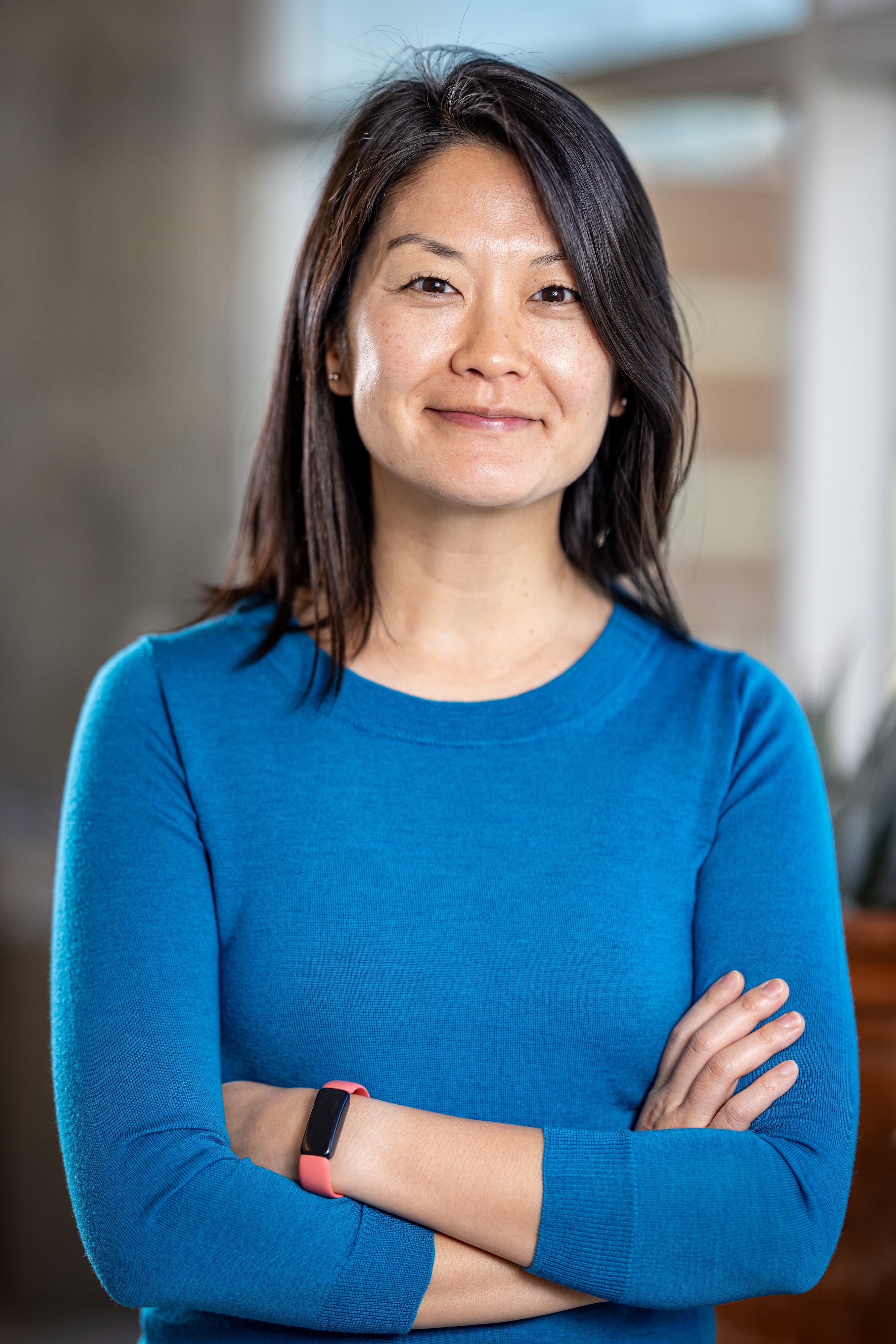 Profile photo of a smiling person in a blue shirt.