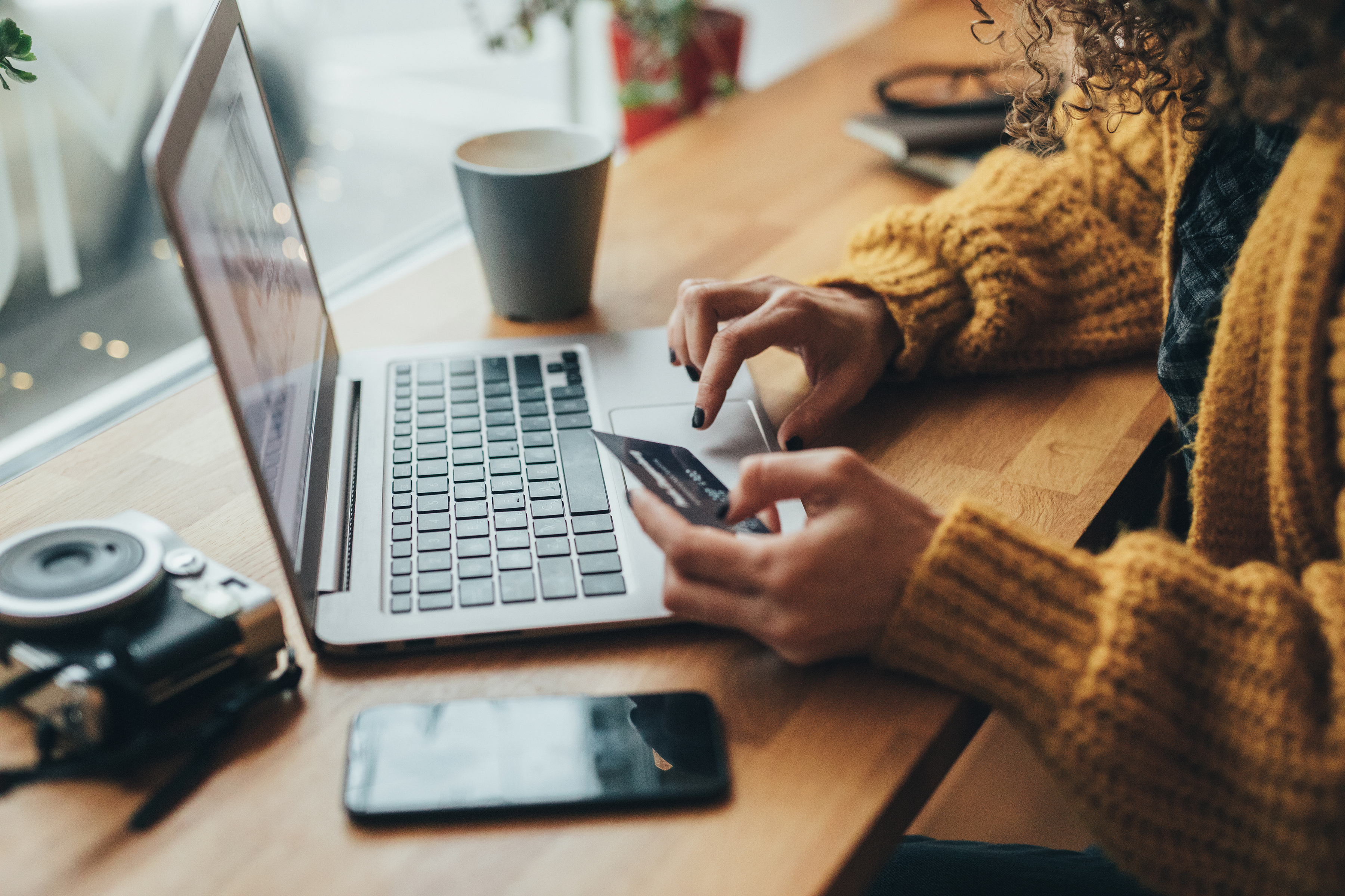 Individual paying a credit card on their laptop