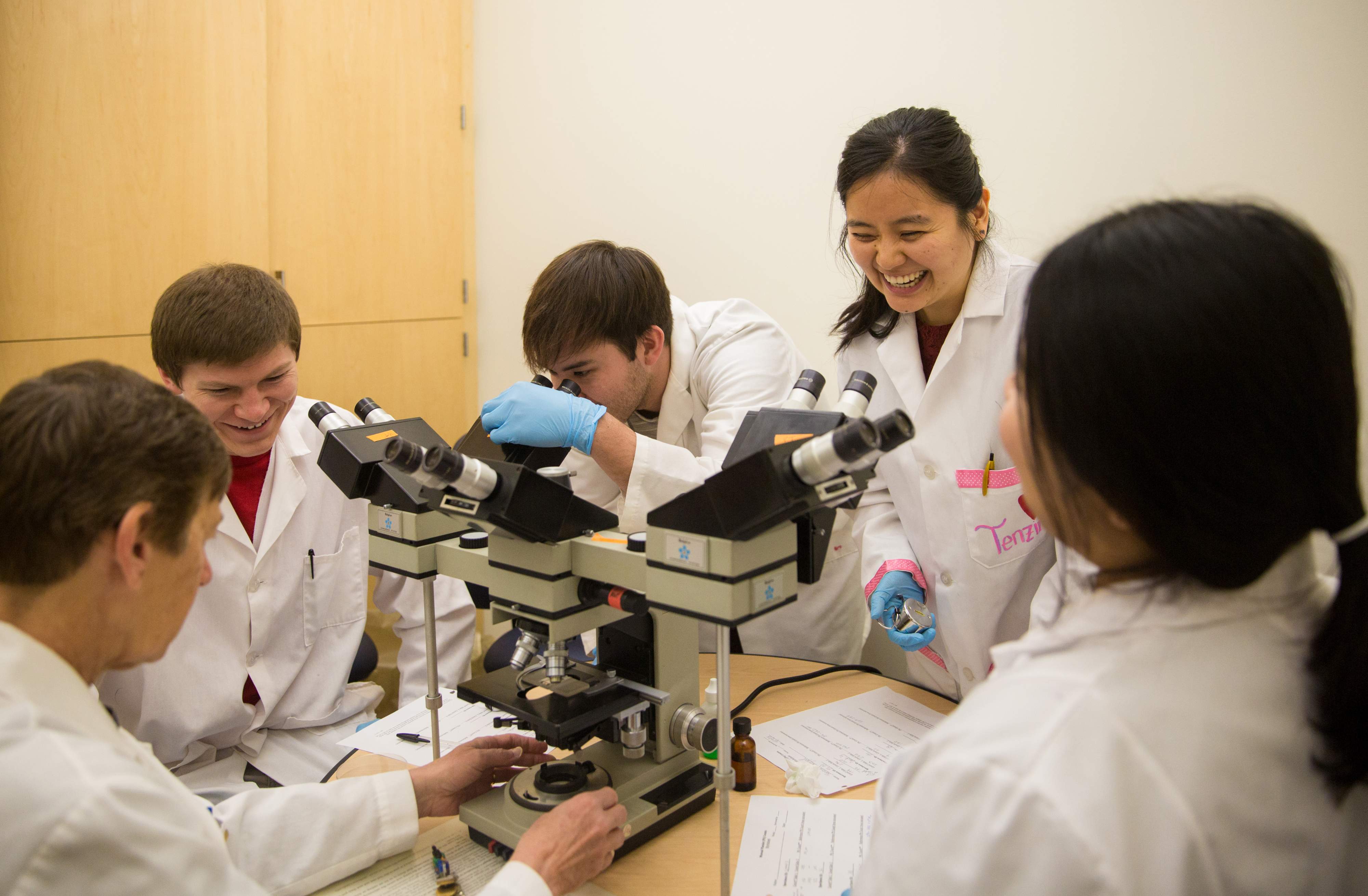 Medical students using microscopes.