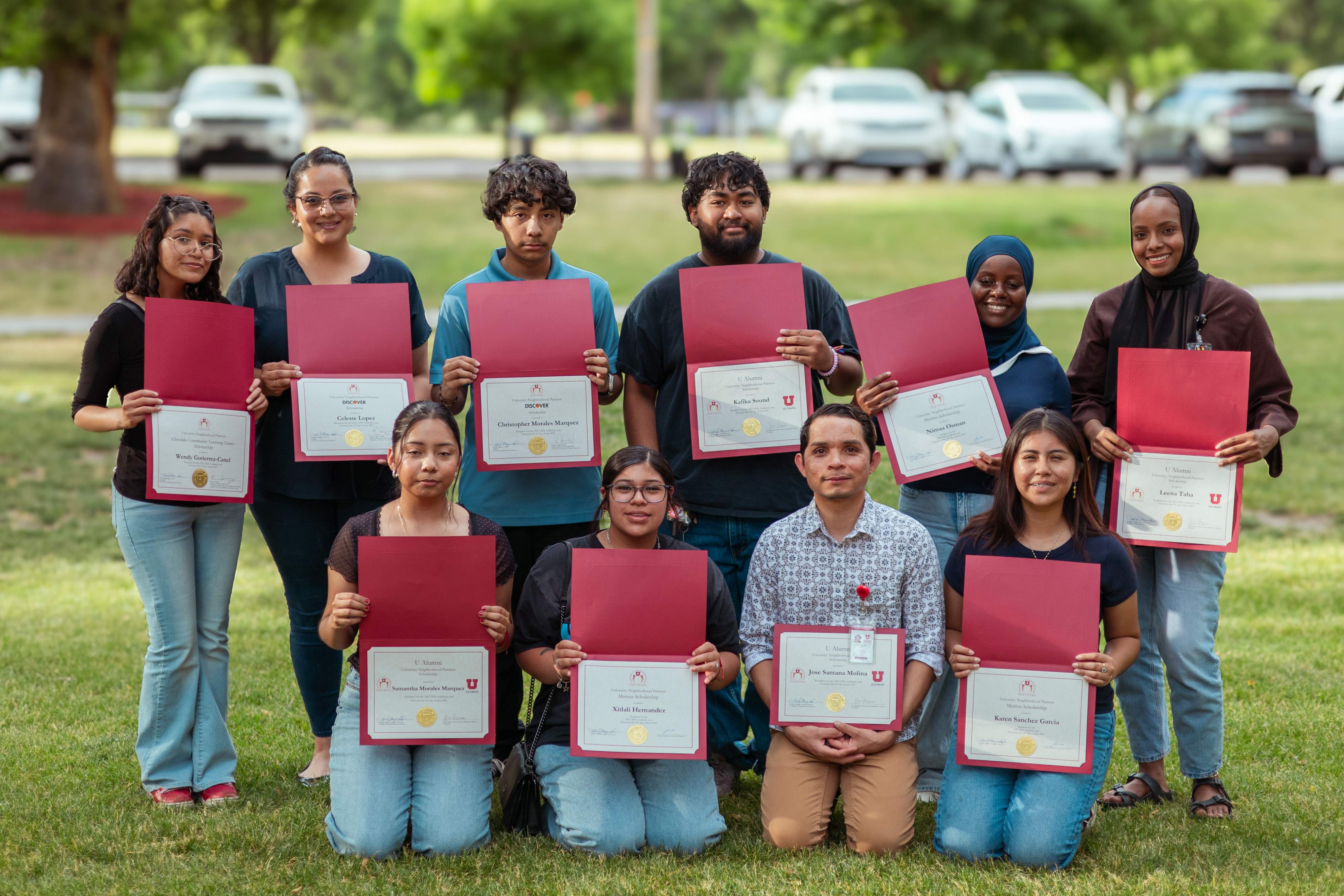 Scholarship recipients are recognized during the kickoff of Partners in the Park, a summer program hosted by University Neighborhood Partners.