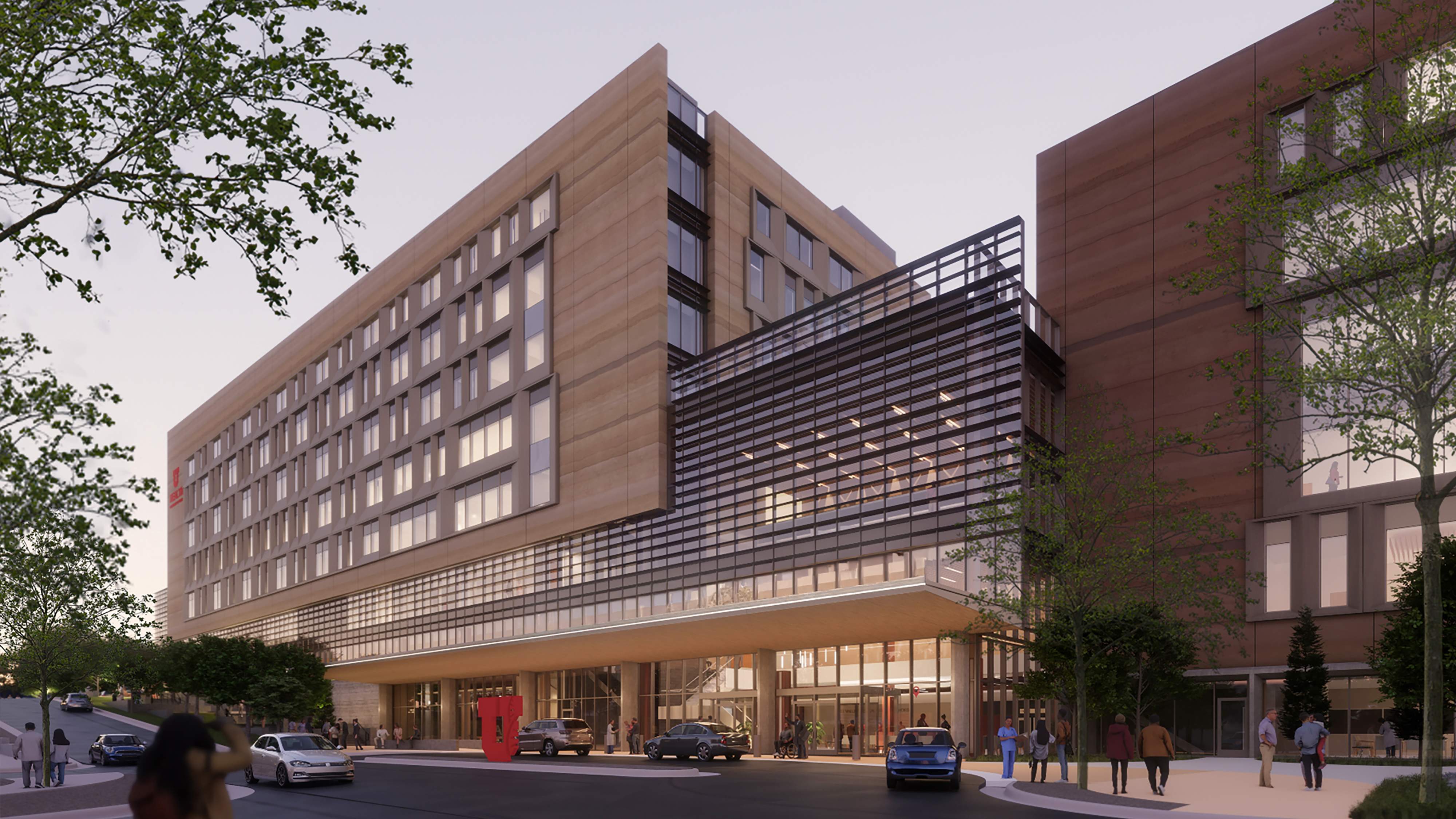 A conceptual rendering of the University of Utah Eccles Health Campus and Eccles Hospital in West Valley, showing the main entrance at night.