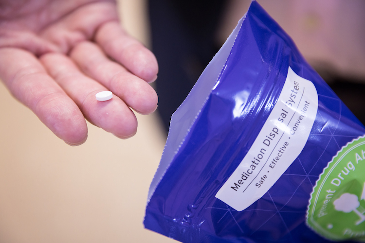 An opioid pill before being placed into a drug disposal kit.