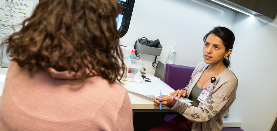 Health coach talks to a patient.