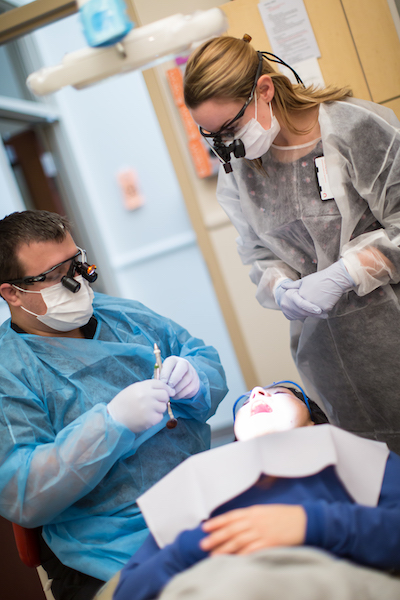 Bullock supervising dental student at South Main Clinic