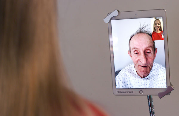 HELP volunteers use iPads to connect virtually to hospitalized older adult patients at University of Utah Hospital.