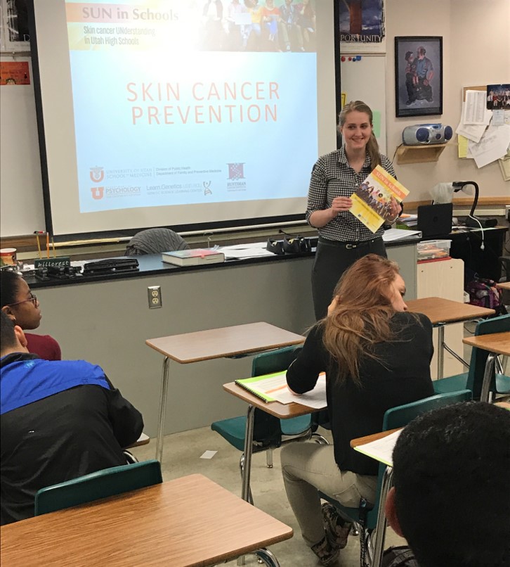 Kelsey Zaugg presents skin cancer prevention materials to a classroom of students for the SUN in Schools Program.