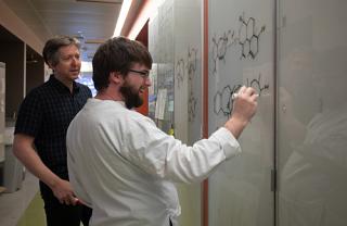 Eric Schmidt Lab, two people writing on whiteboard