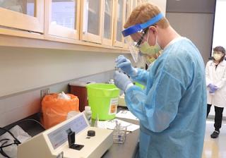 Students test a patient specimen for serum total protein concentration.