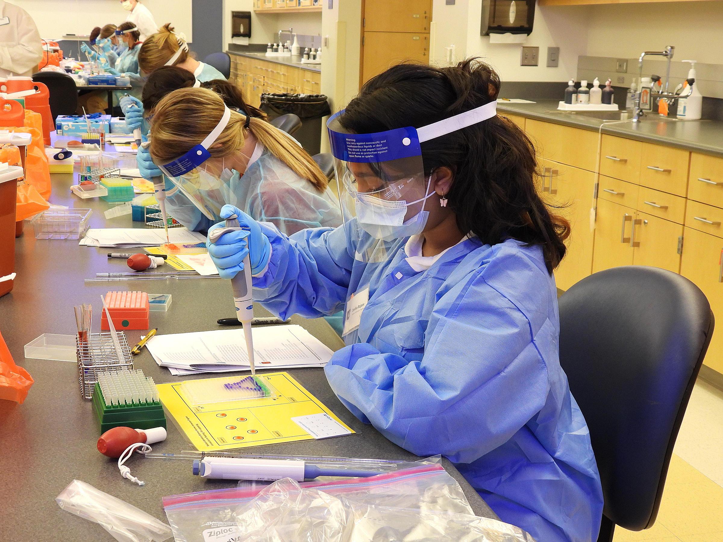 Lab student using micropipette in classroom