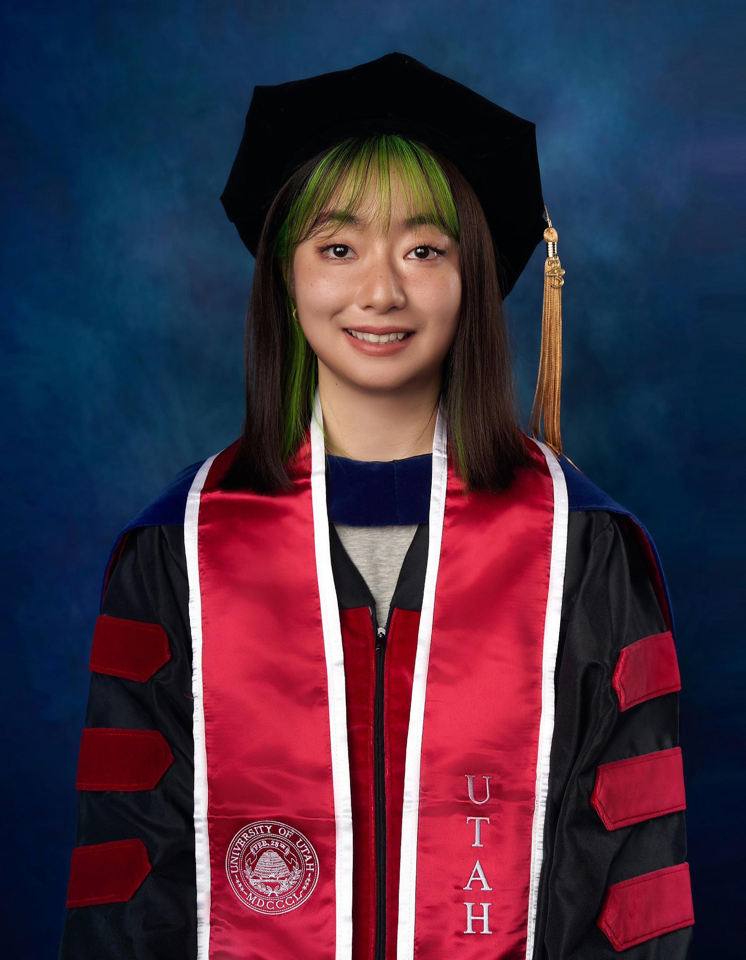 Siqi Hu wearing a graduation cap and robe