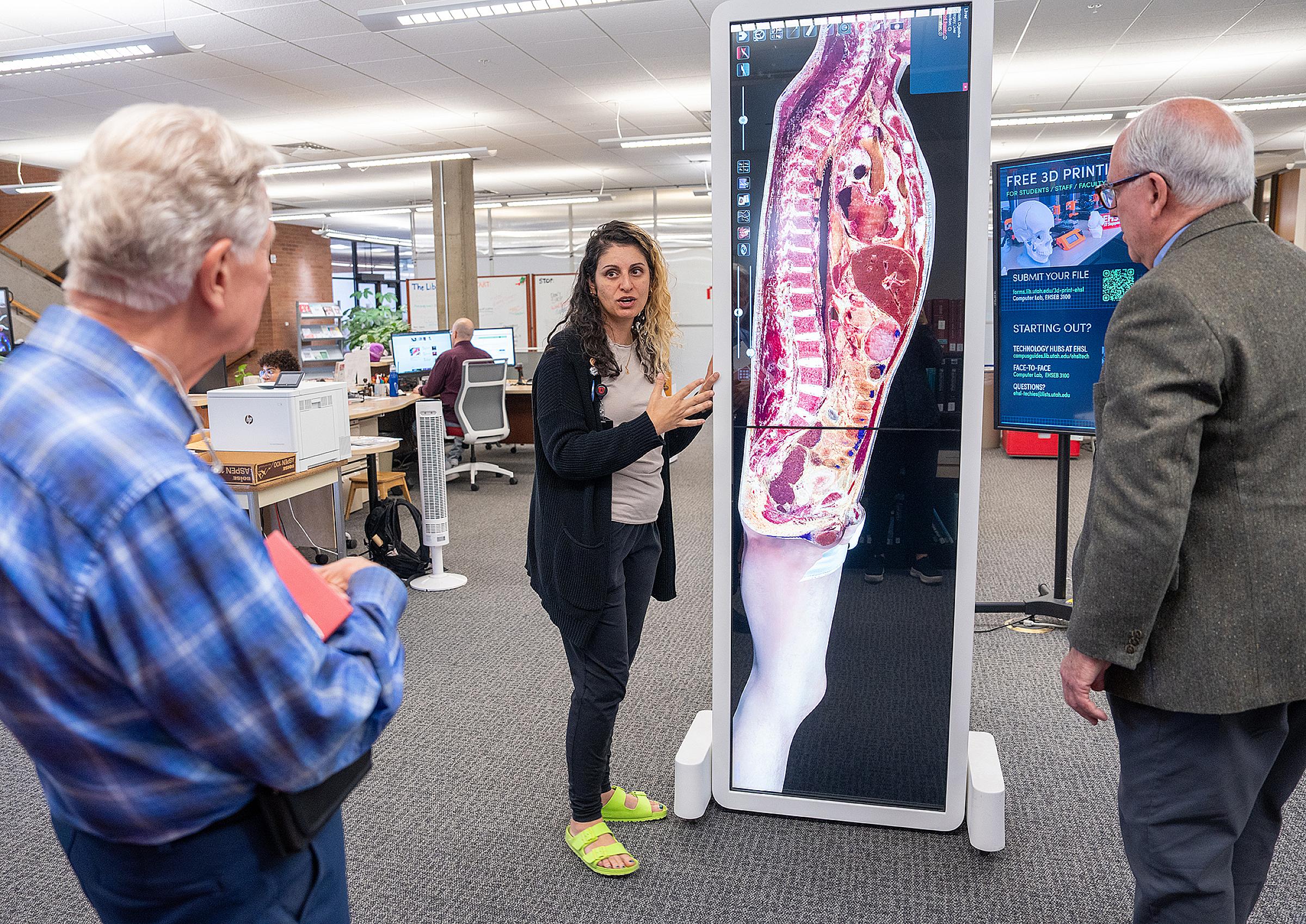 Eccles Health Sciences librarian Donna Baluchi leads alumni on a tour of the library.