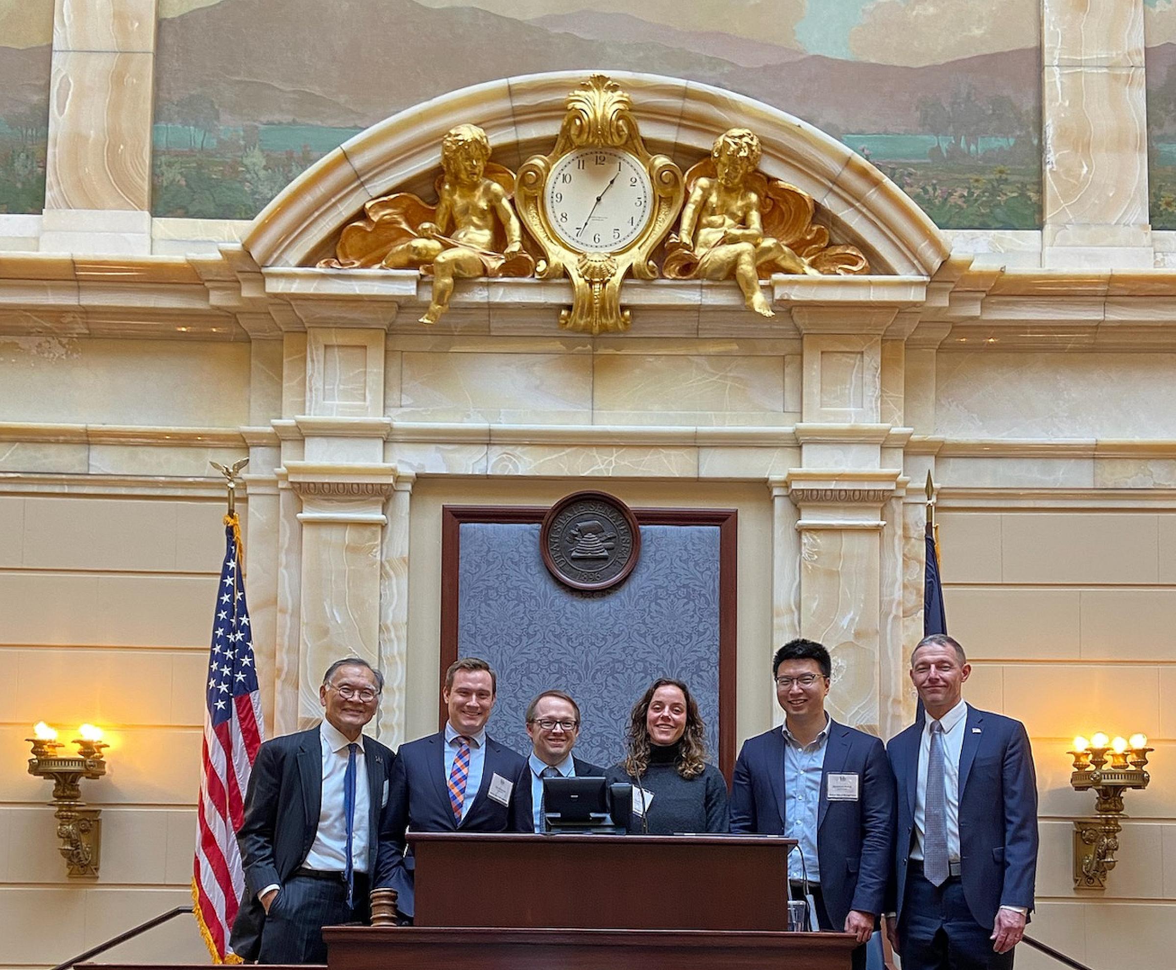 Brian Shiozawa, MD, (left) at the Senate Podium with University of Utah medical students and Sen. Michael Kennedy, MD (right).