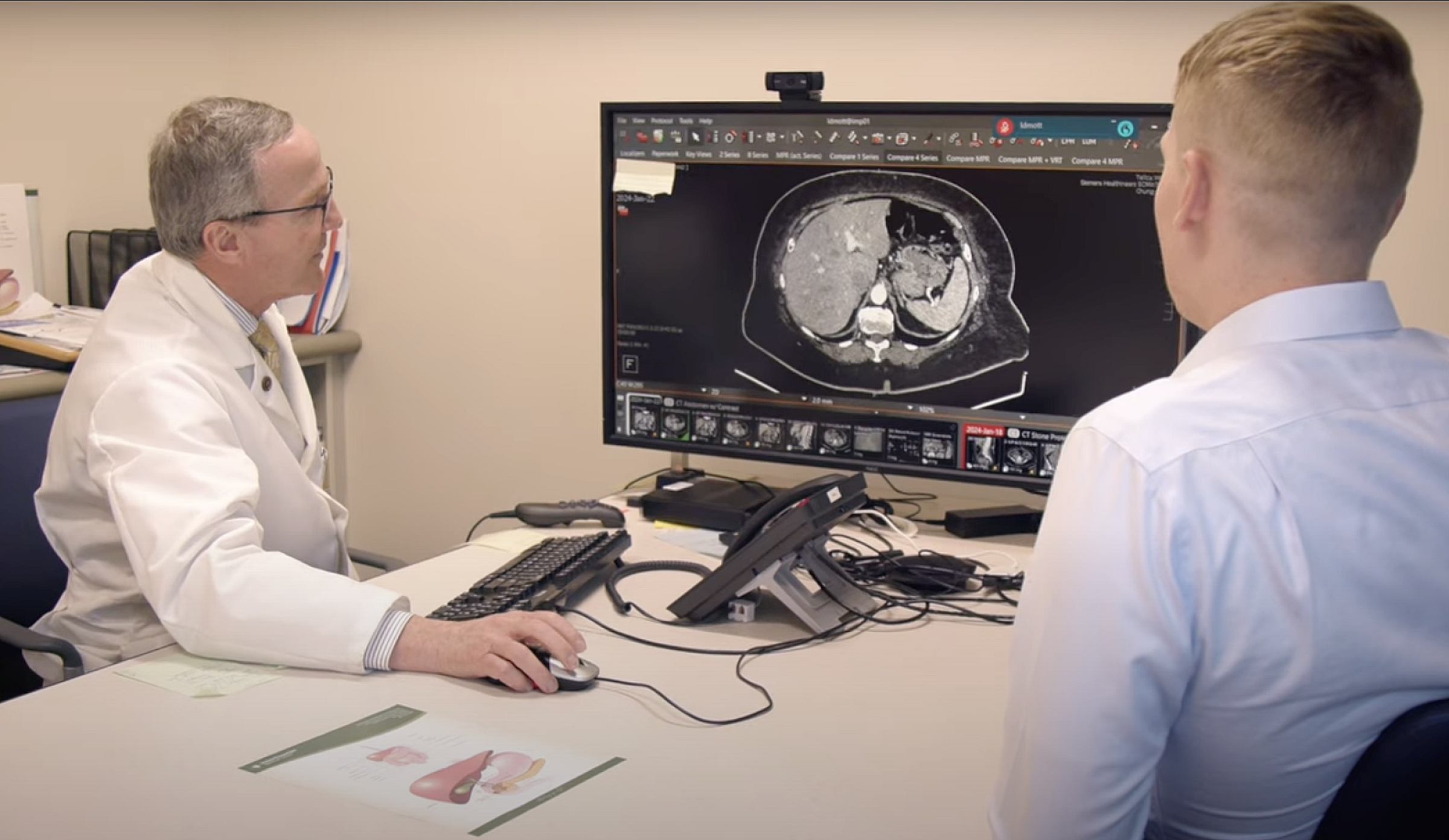 Mark Ott, MD, an LIC preceptor, reviews CT scan with University of Utah medical student Seth Bhien.