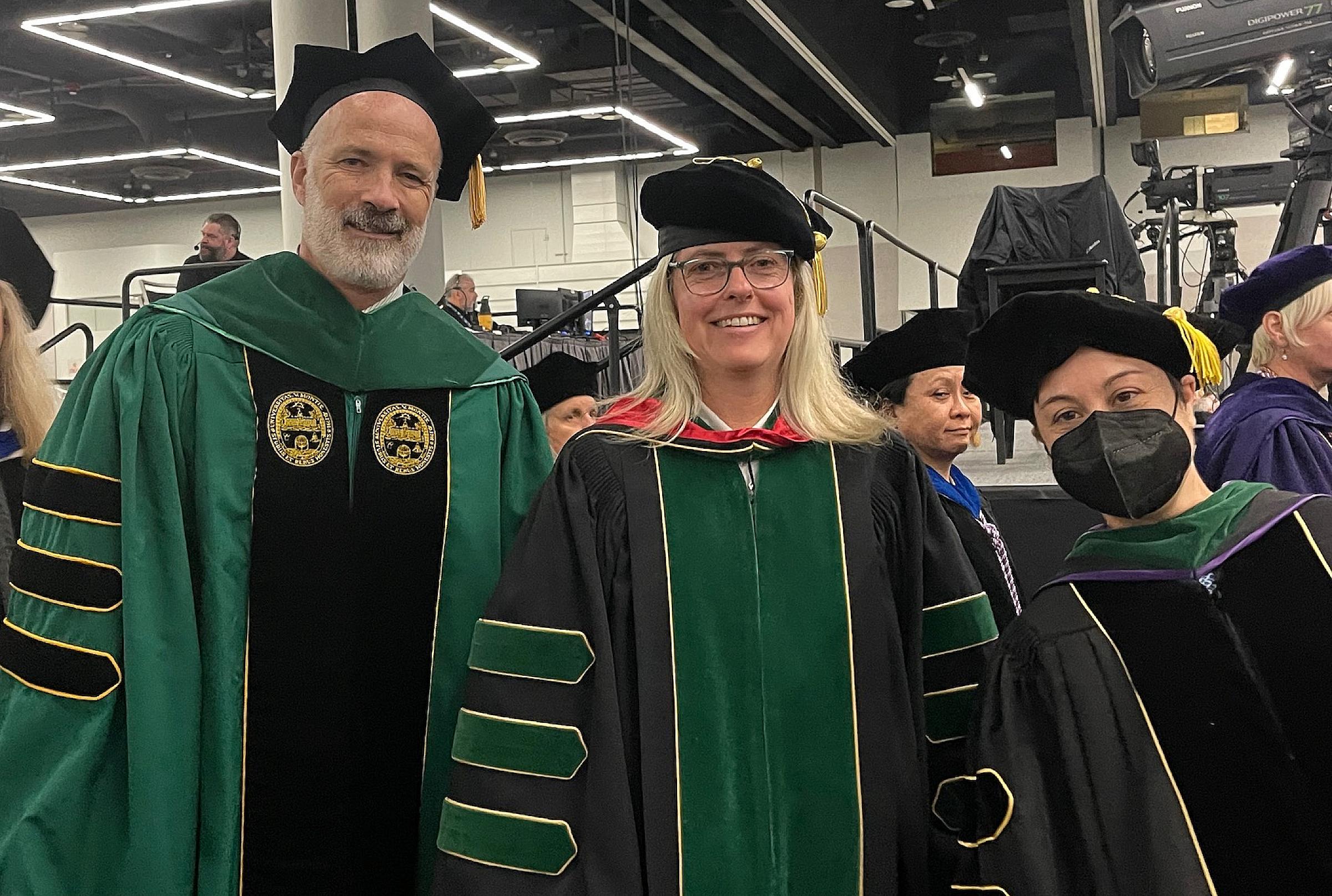 Tracy Bumsted, MD, MPH, (middle) participates in graduation hooding ceremony with colleagues Robert Cloutier, MD, and Rebecca Cantone, MD, at Oregon Health & Science University Medical School, 2023. 