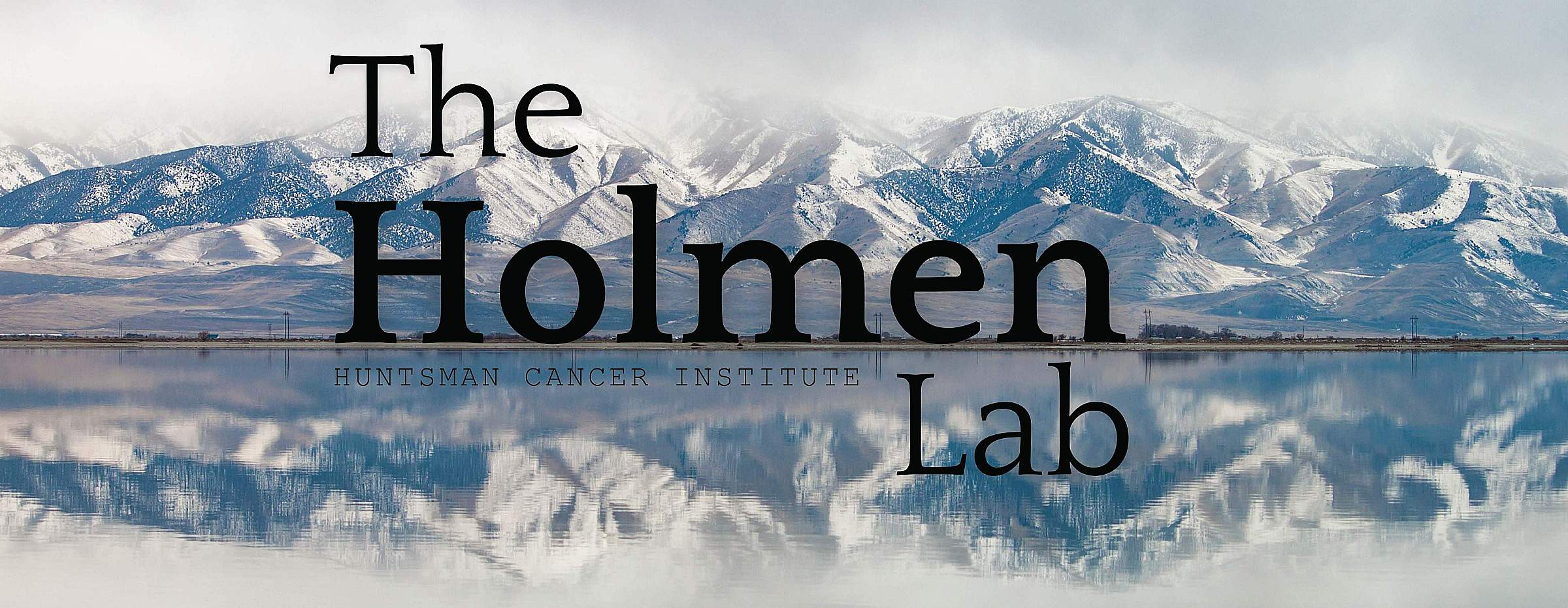 The Holmen Lab text in front of a snowy mountain