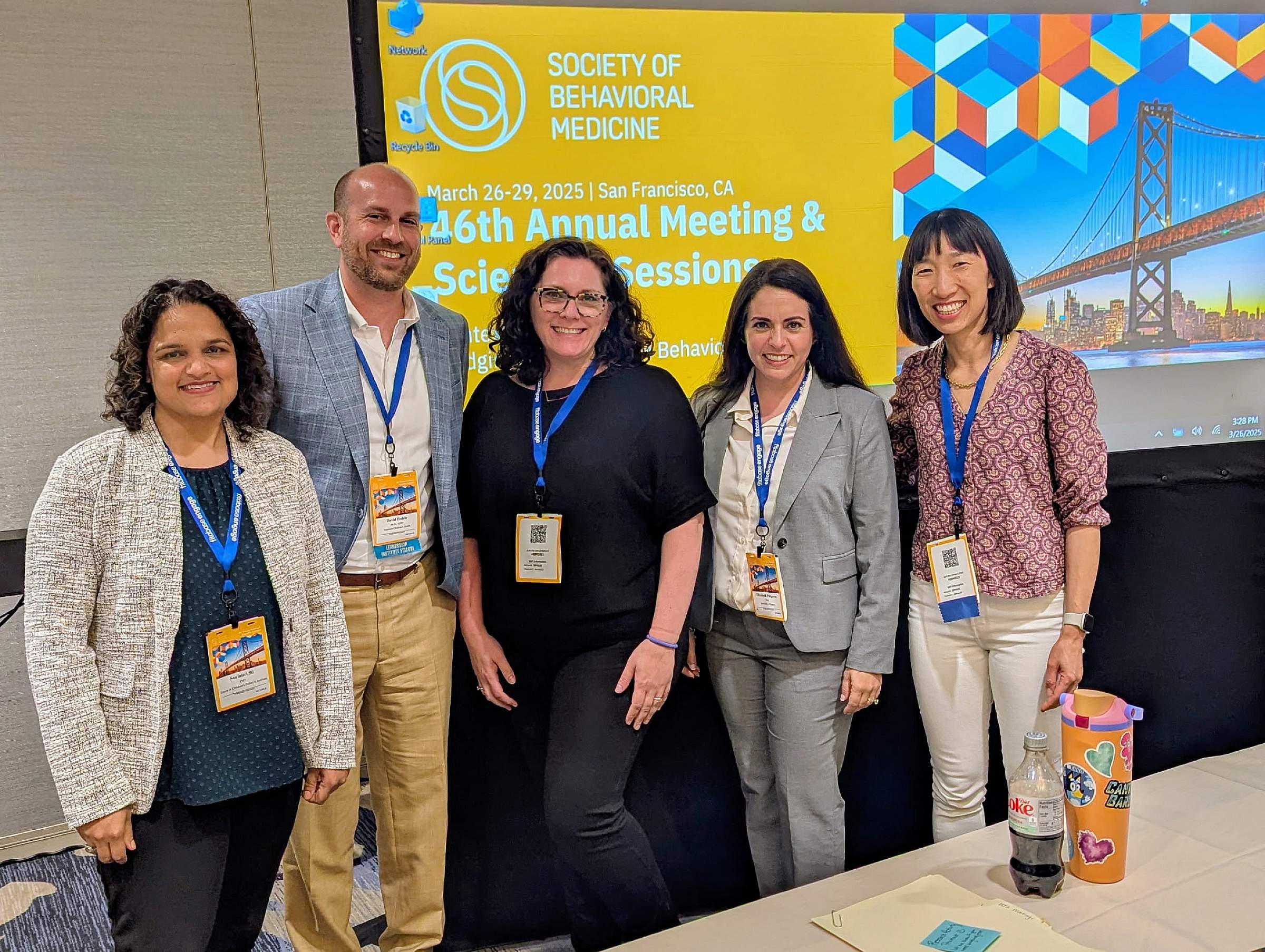 Yelena Wu, PhD, (right) standing with other attendees at the Society of Behavioral Medicine's 46th Annual Meeting & Scientific Sessions