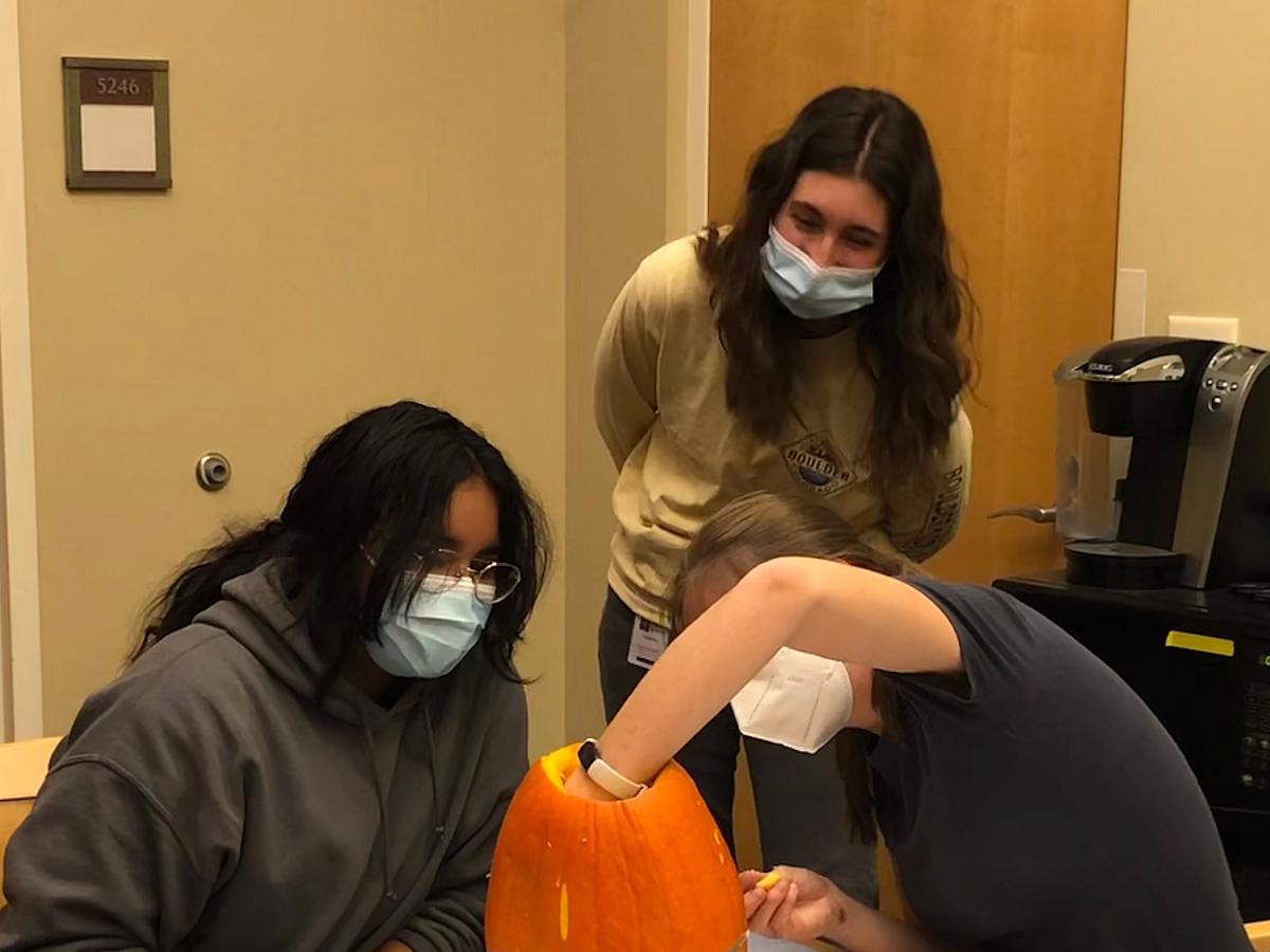 Young Lab members carving pumpkins