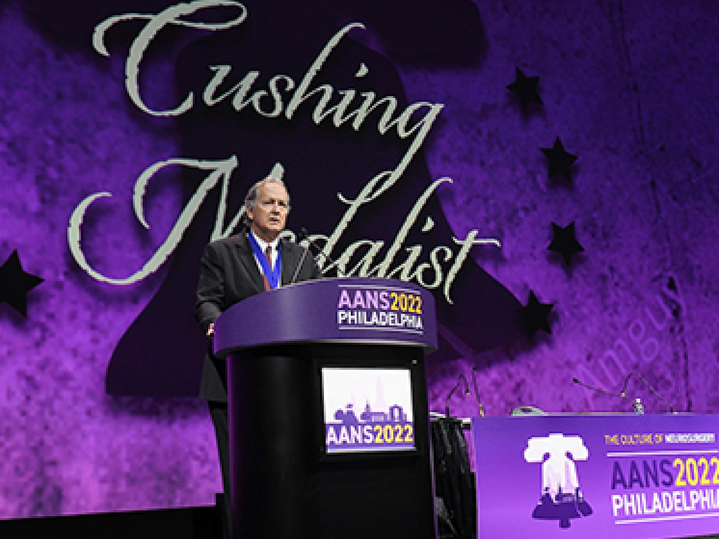 William Couldwell, MD, PhD, at a podium accepting the Cushing award