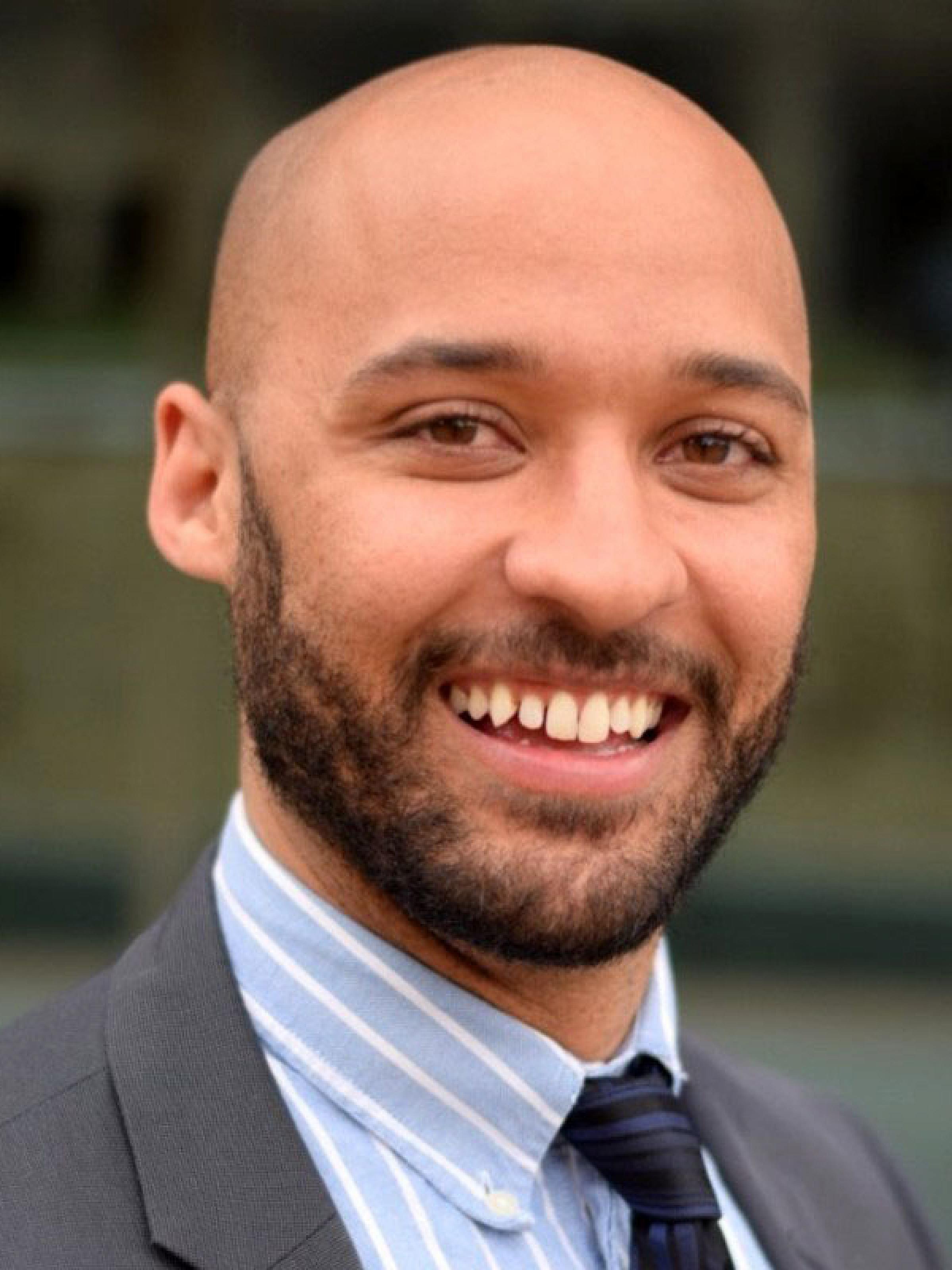 man in suit smiling at camera