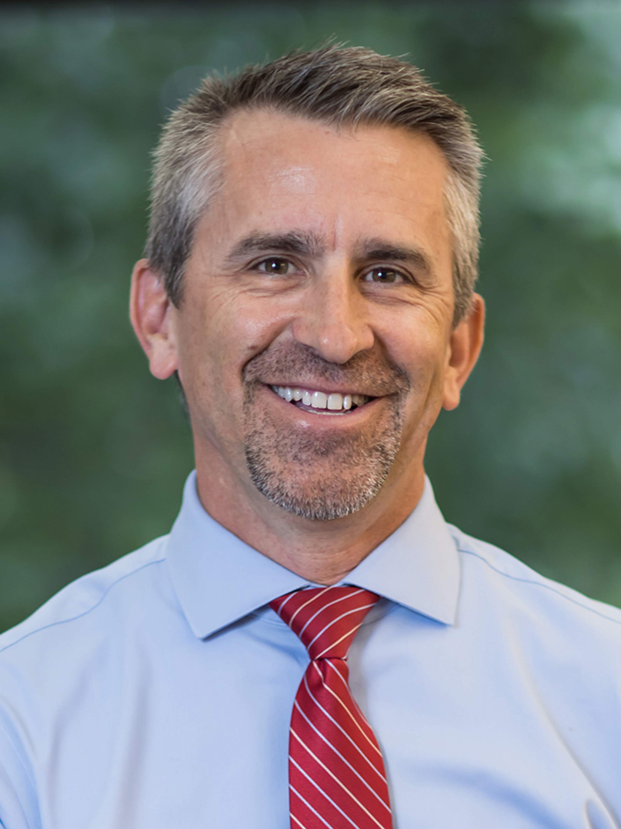man in suit smiling at camera