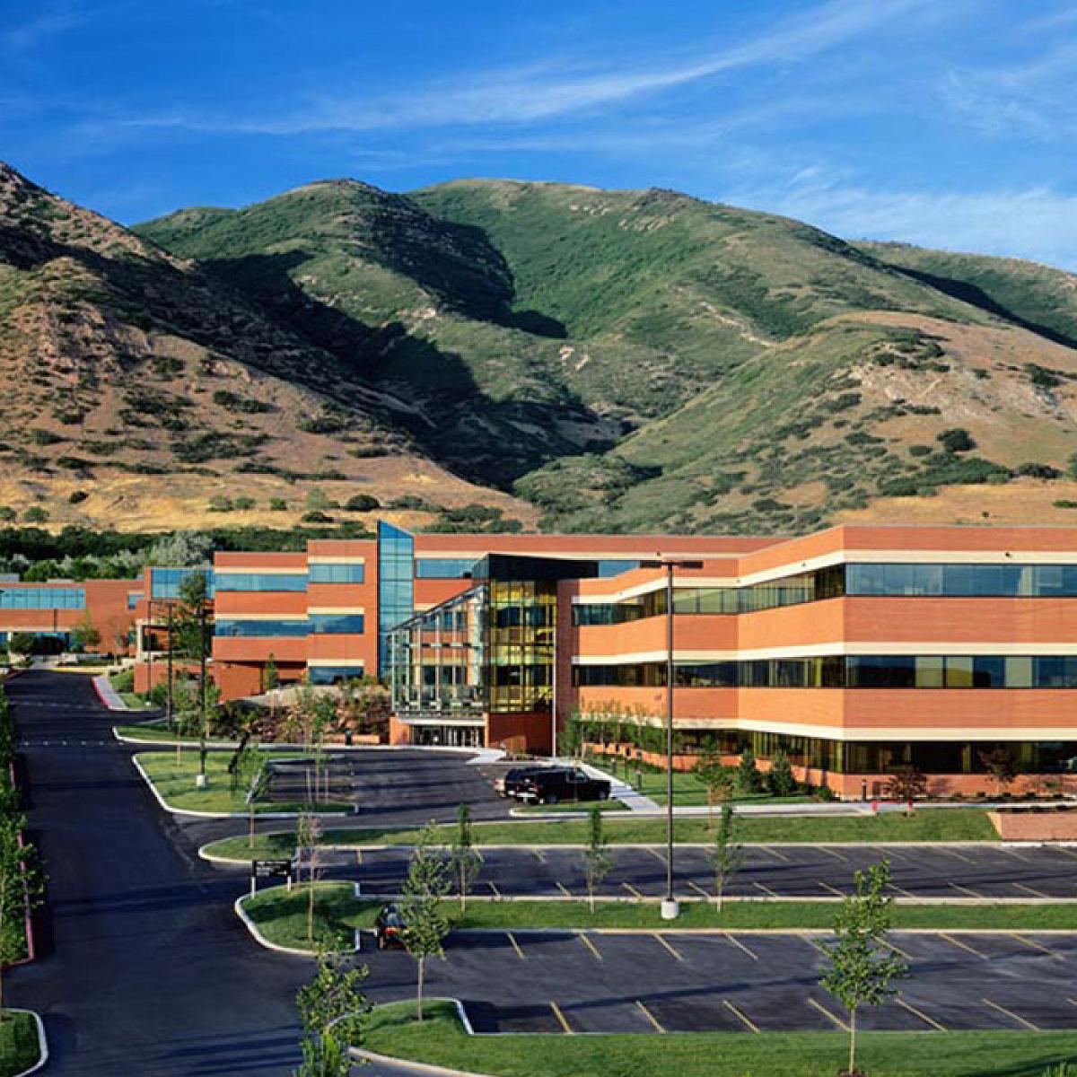 Aerial View of Campus with Buildings, Parking Lot, and Mountain