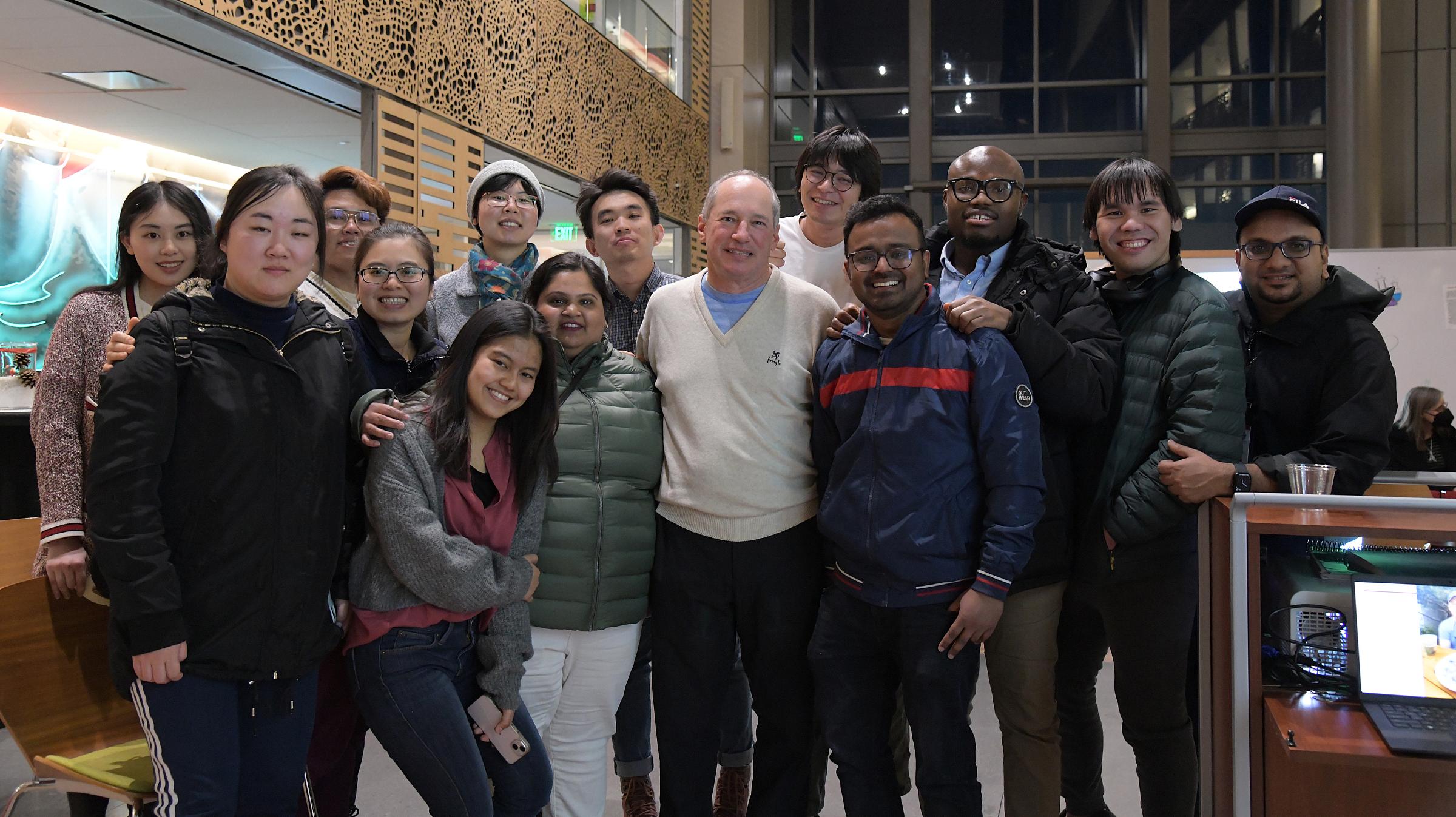 Joe Biskupiak, PhD, MBA, with current and former students at his retirement party, December 2022.