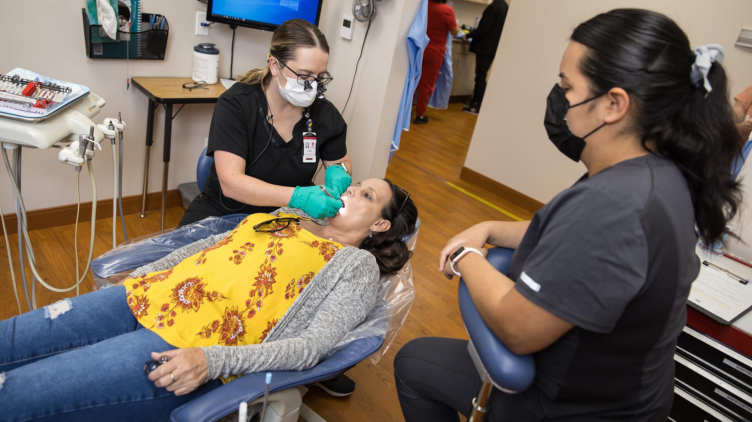 two providers administer a dental exam