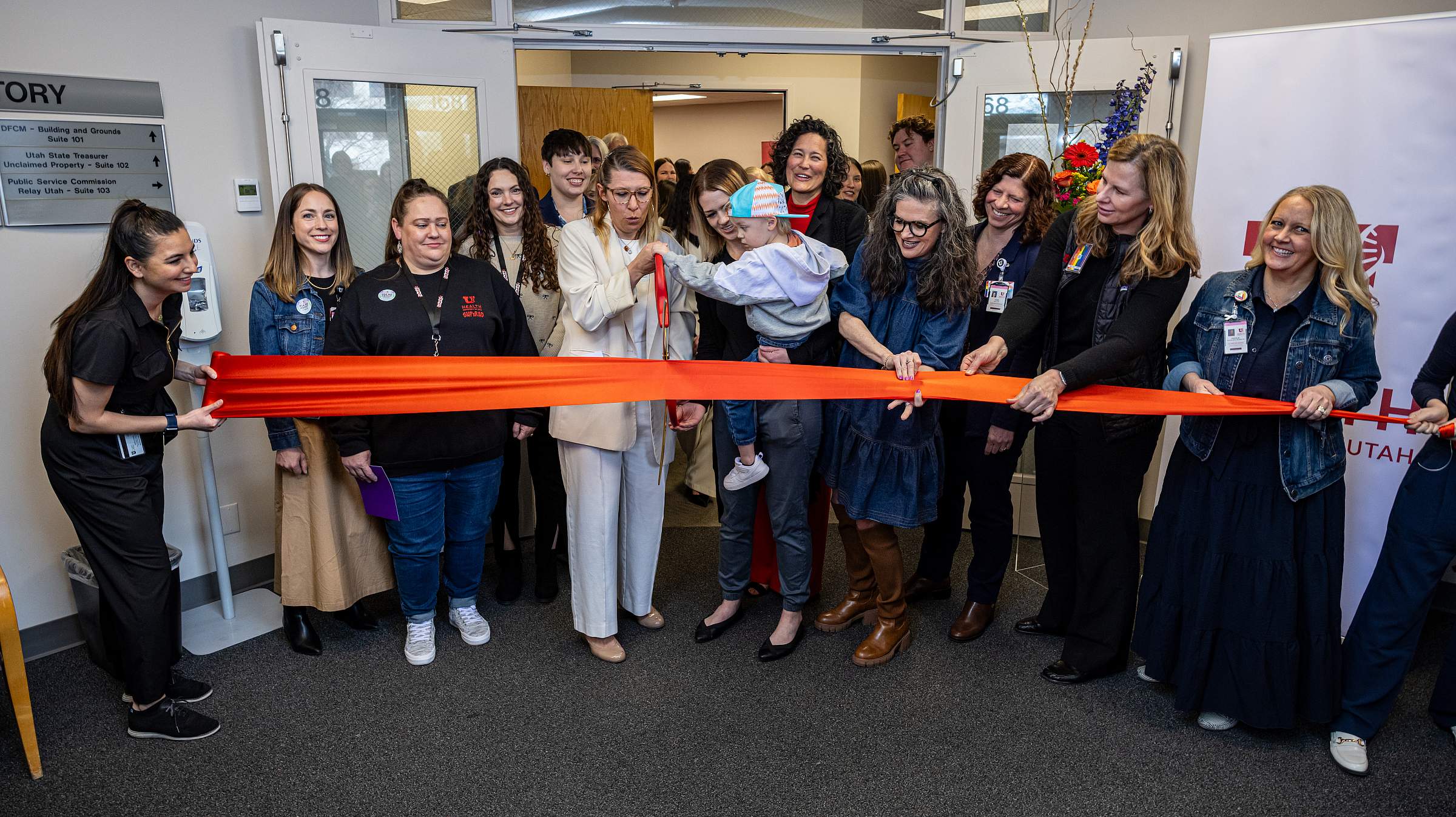The SUPeRAD team cuts a red ribbon.